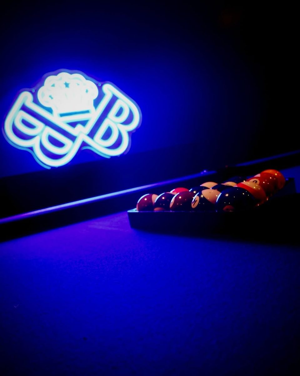 The pool table under the Baller Bossez neon