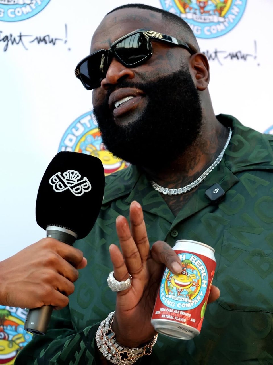 Rick Ross speaking into a Baller Bossez microphone